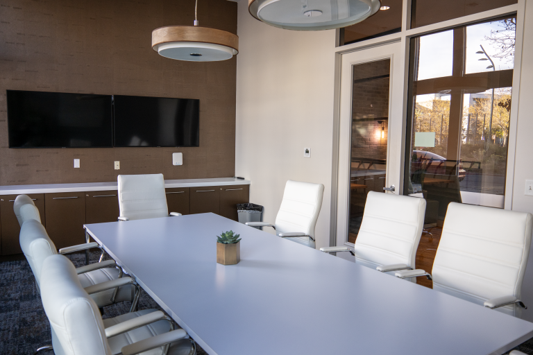 Spacious and modern conference room with sleek furniture and natural lighting.